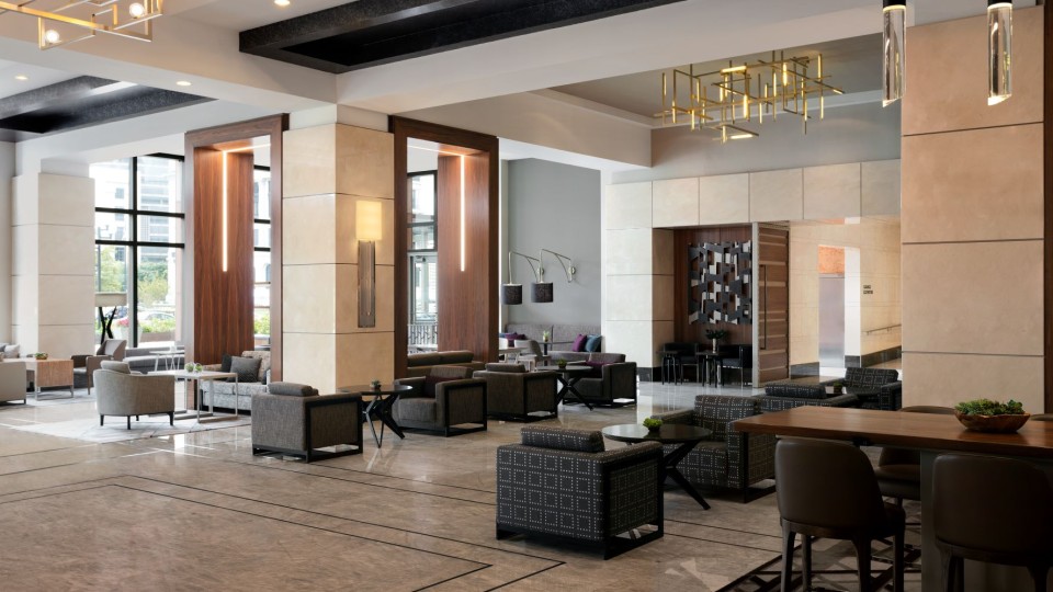 Hotel lobby with chairs and tables.