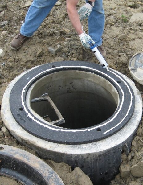 a worker installs the EJ INFRA-RISER Adjustment Riser