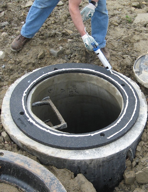 a worker installs the EJ INFRA-RISER Adjustment Riser