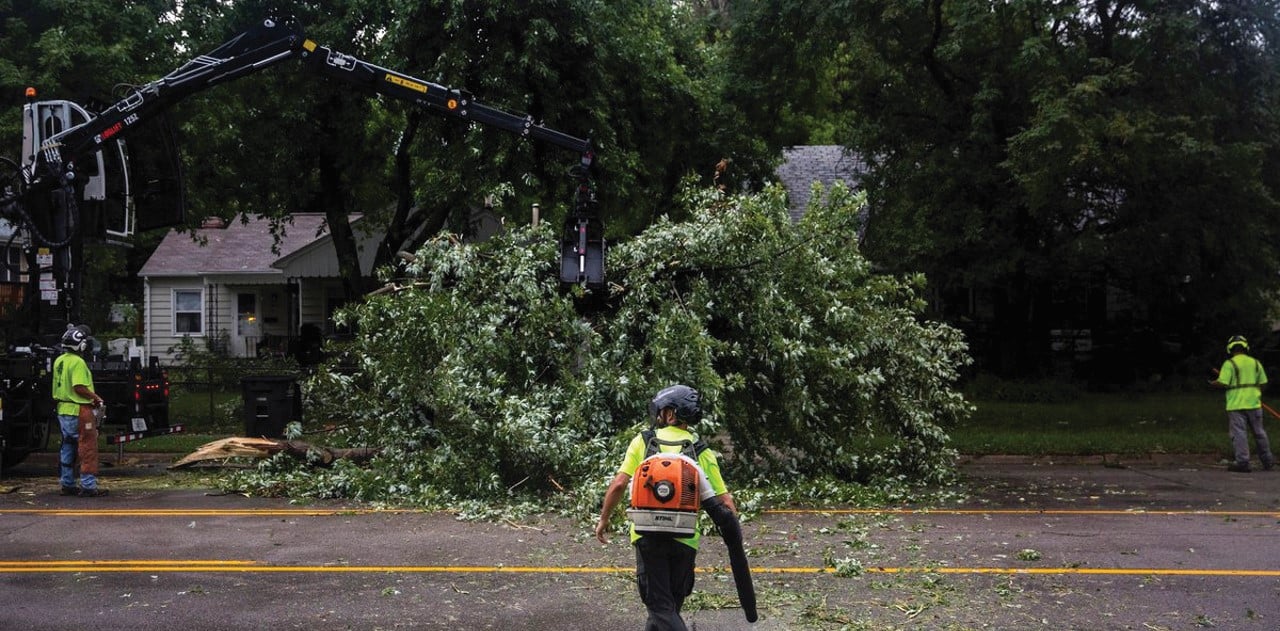 a photo of public works first responders removing downed trees