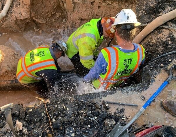 a photo of public works first responders repairing a water main