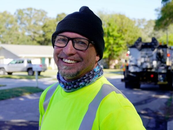 a photo of a public works professional smiling
