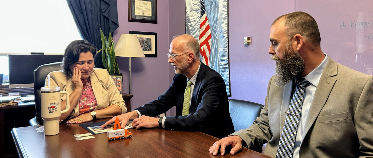 a photo of APWA Project of the Year Winners Rob Gelder and Joshua Hanes of Poulsbo, Washington, visiting with US Representative Emily Randall