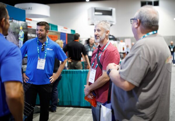 a photo of PWX attendees meeting with exhibitors
