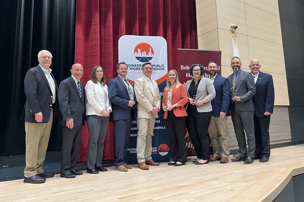 a photo of leaders from the Engineering & Public Works Roadshow and Doherty Memorial High School pose for a photo at the school