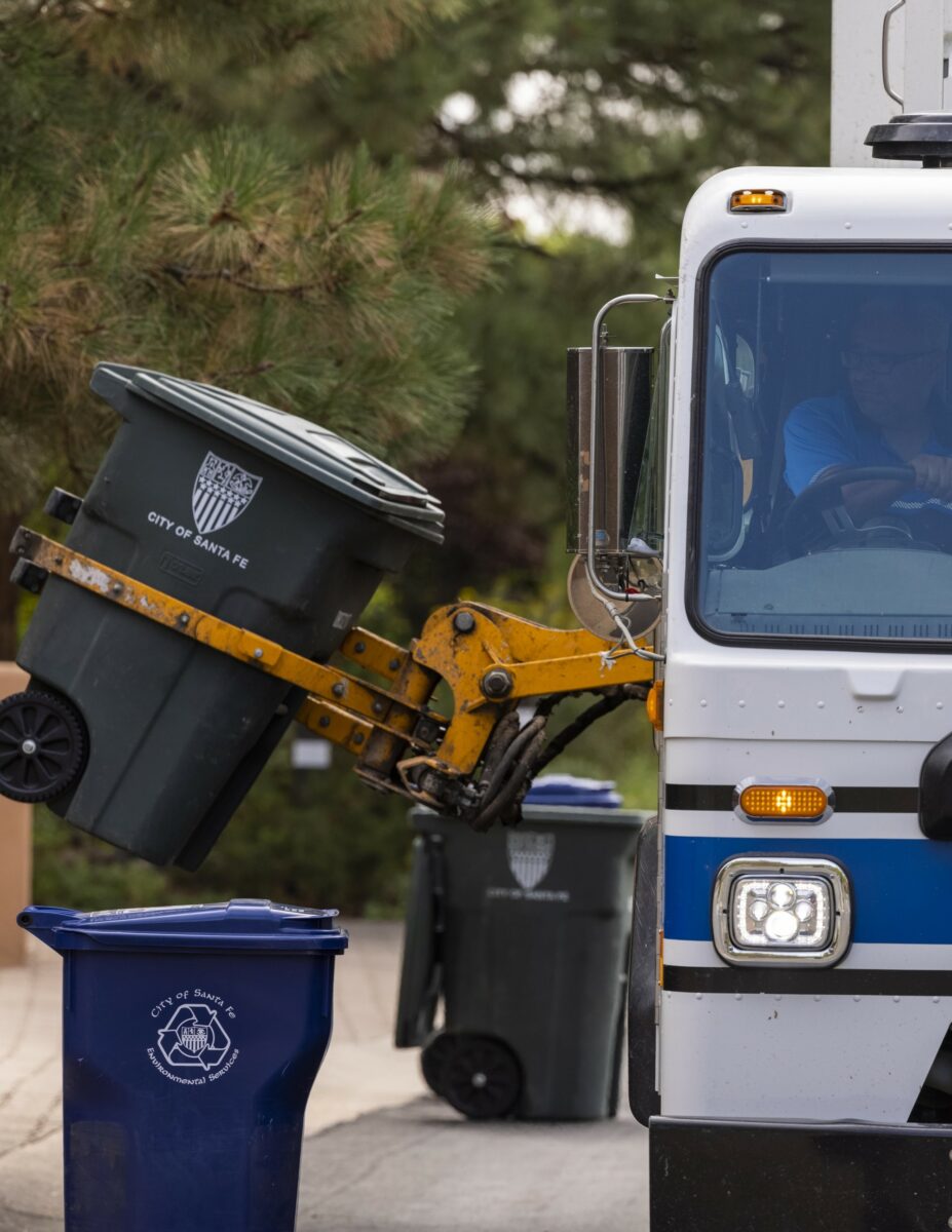 a photo of an automated side loader picking up a cart