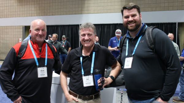 Snow Conference attendees posing for a photo in the exhibit hall