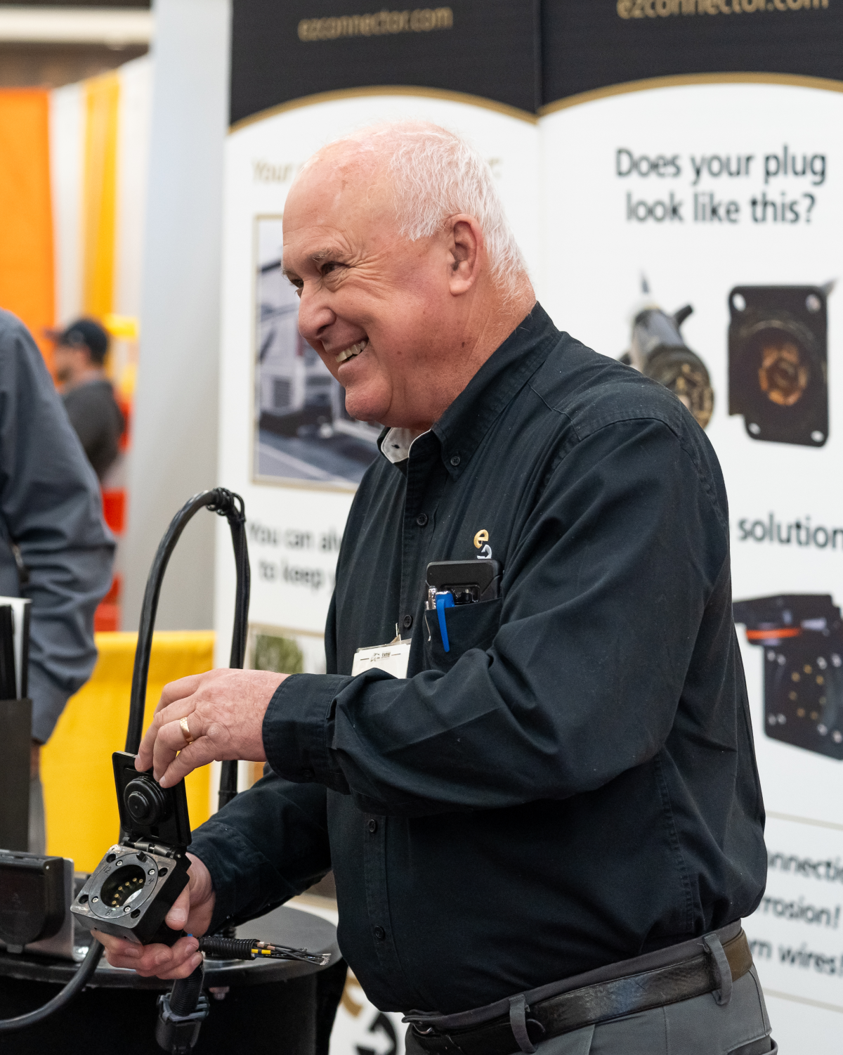 A man demonstrates how a product works on the exhibit floor at the APWA Snow Conference.