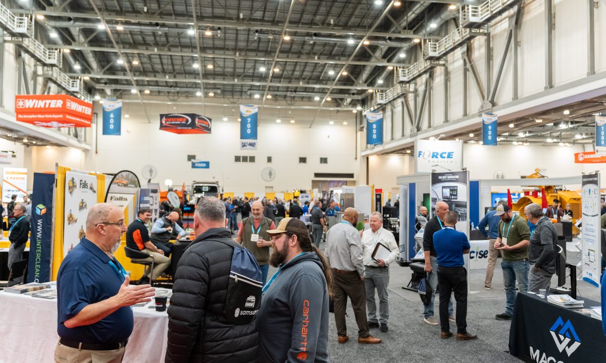 Dozens of people chat with each other at booths in the exhibit hall at the APWA Snow Conference.