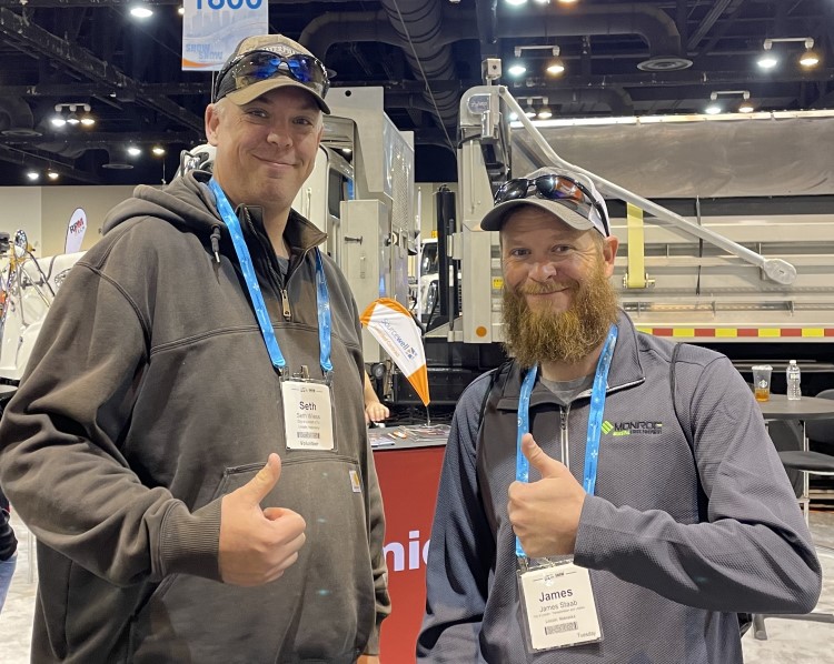 Snow Conference attendees give the thumbs up on the exhibit floor