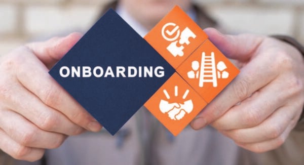 An illustration of hands holding blocks that say, "Onboarding" and related icons.
