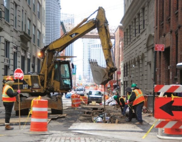 a photo of public works professionals working in the road