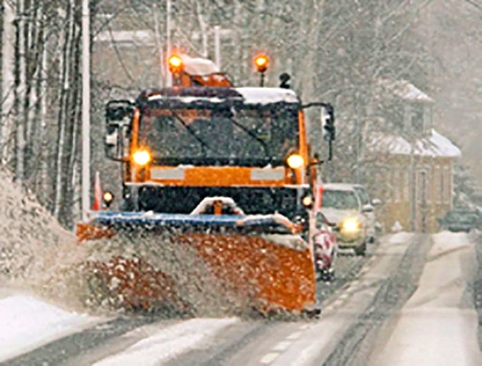 A snow plow clearing a street