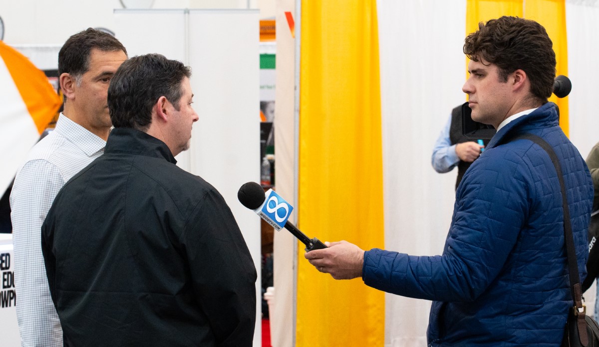 an attendee is interviewed by local media at the North American Snow Conference