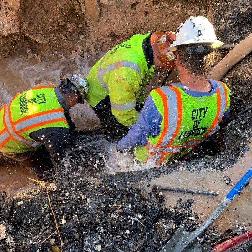 a photo of public works first responders repairing a water main