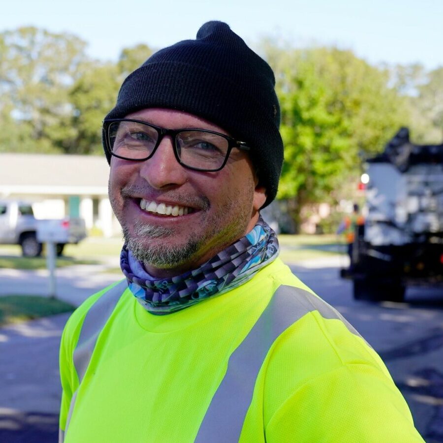 a photo of a public works professional smiling