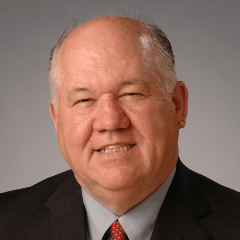 A headshot of APWA Past President Noel Thompson in a suit and tie.
