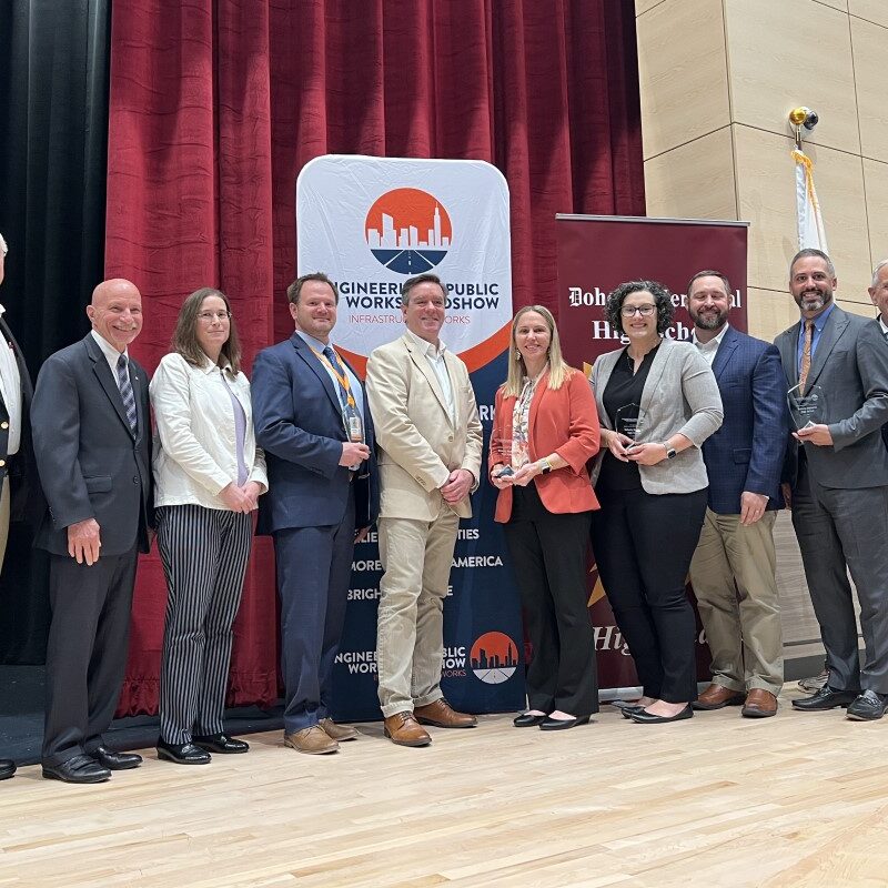 a photo of leaders from the Engineering & Public Works Roadshow and Doherty Memorial High School pose for a photo at the school