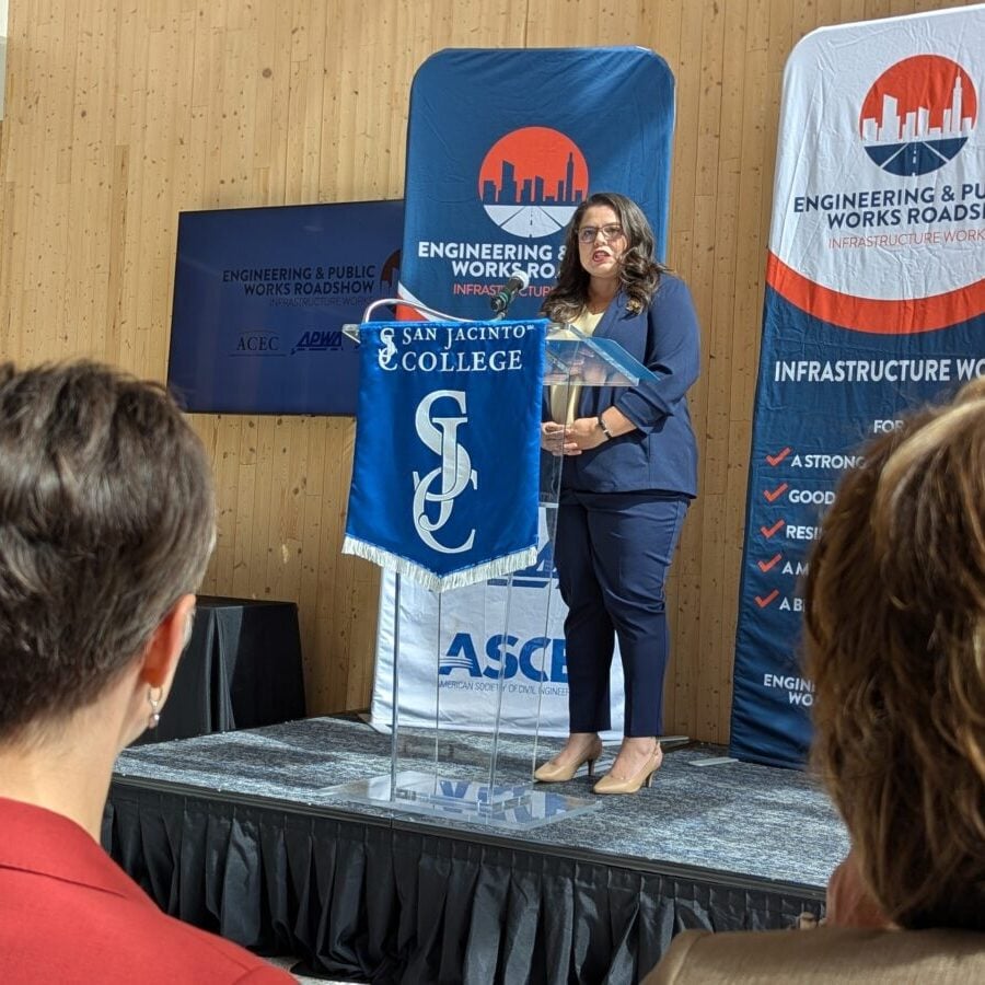 a photo of Kristina Ramirez, P.E., CPM, CFM, speaking at an Engineering and Public Works Roadshow stopped at San Jacinto College