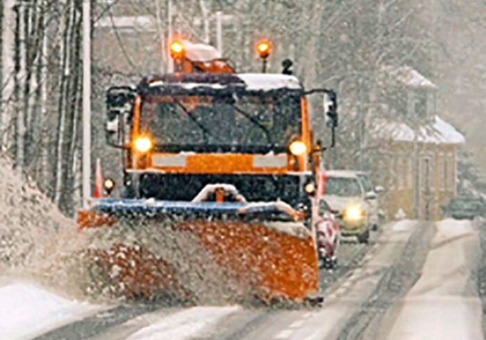 A snow plow clearing a street