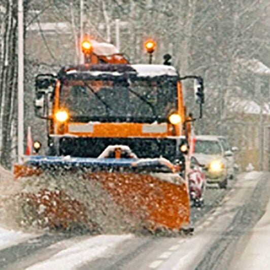 A snow plow clearing a street