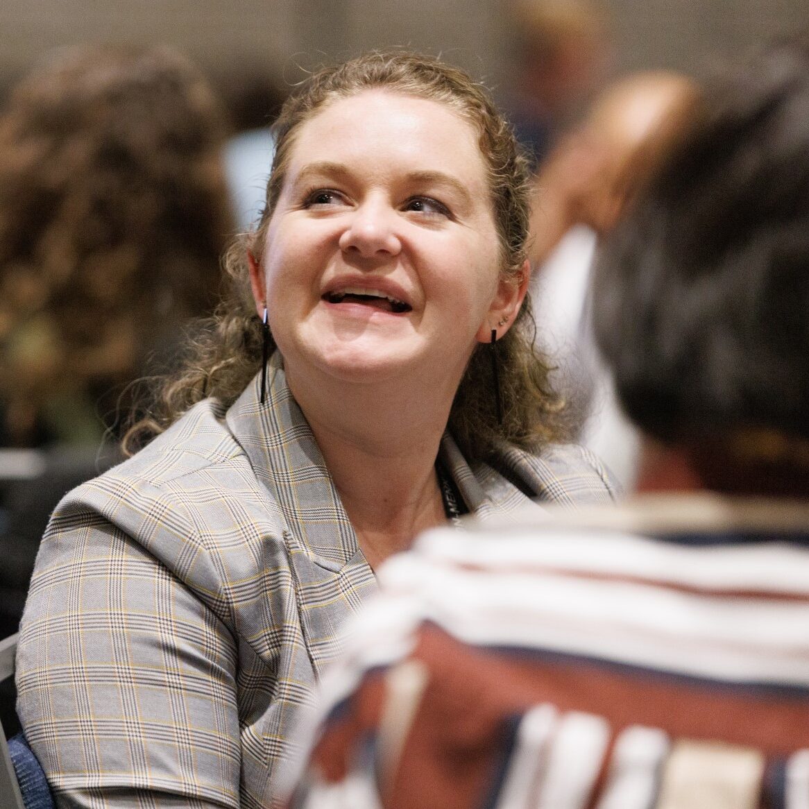a photo of a smiling attendee at the YP Summit