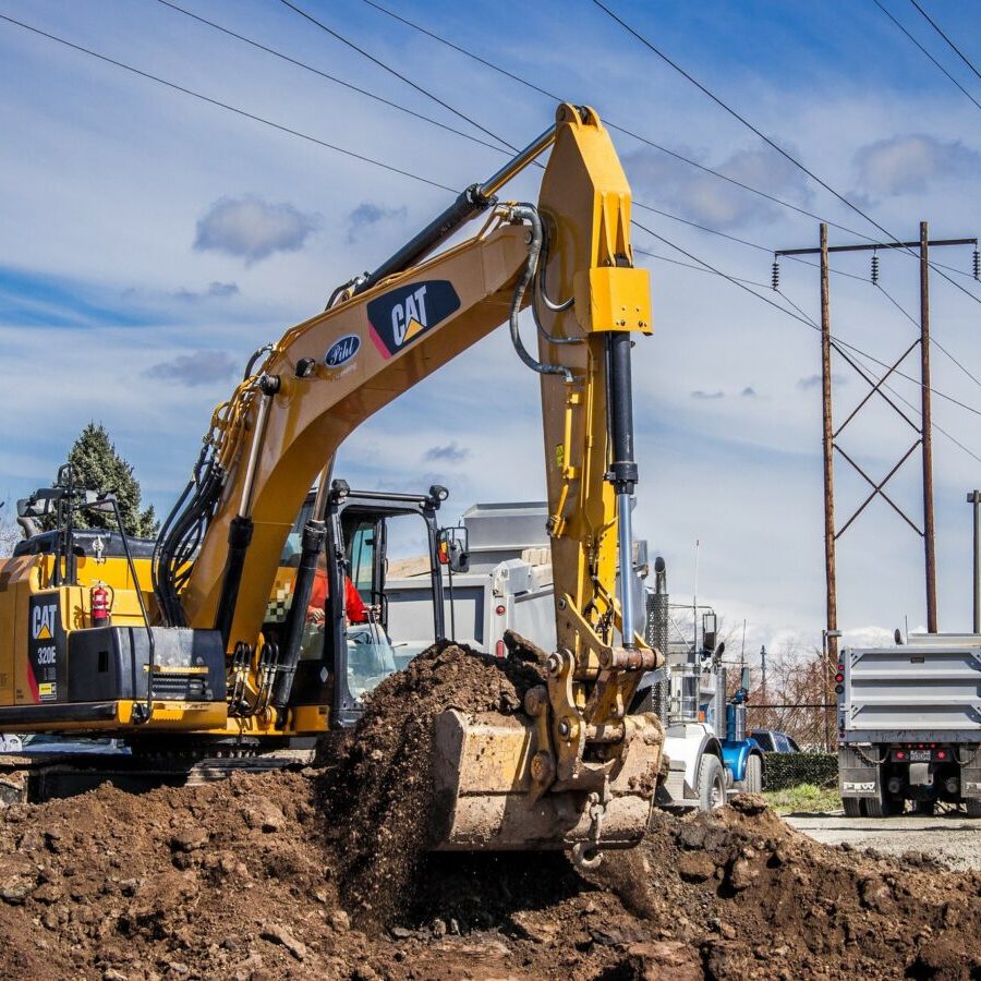 a photo of an excavator scooping dirt
