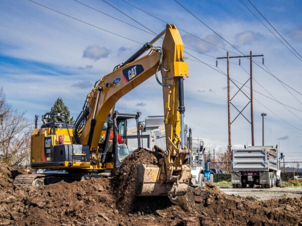 a photo of an excavator scooping dirt