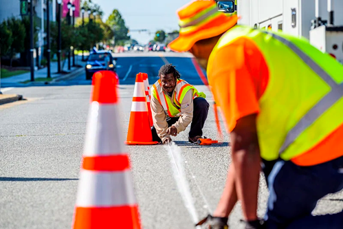 public works road workers public works workers measure a line in the street
