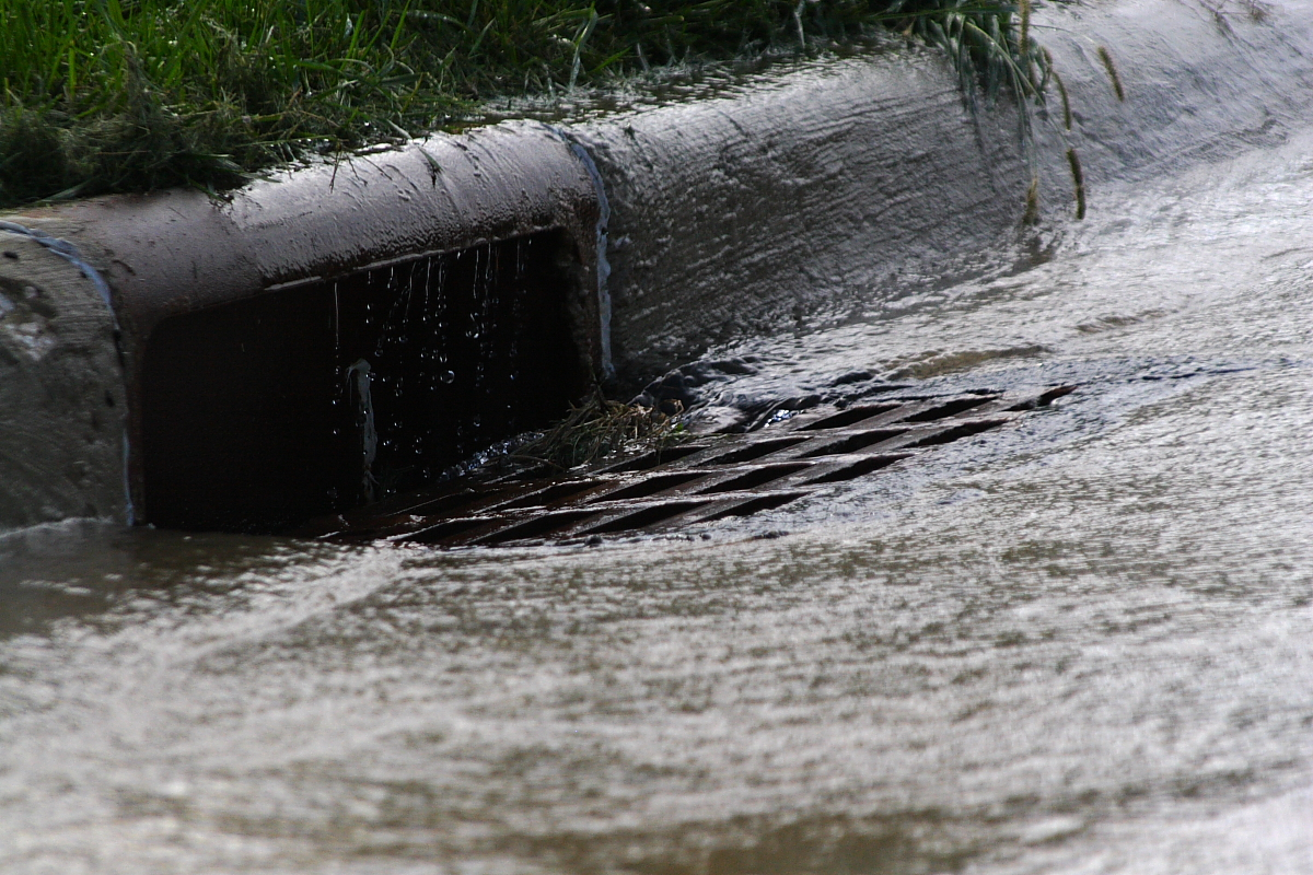 Water flowing into a storm drain.