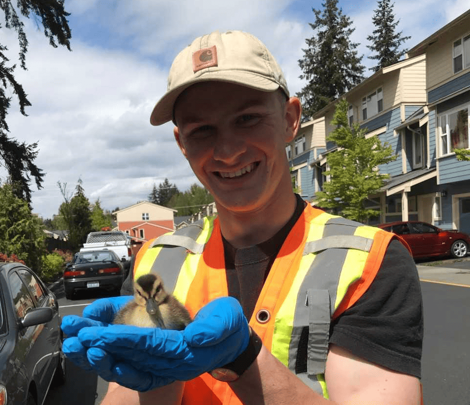 tell-your-story Happy worker holding a duck